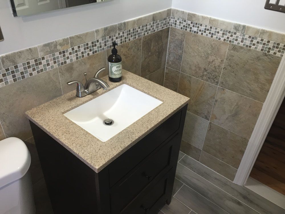 a bathroom with a sink a toilet and a mirror