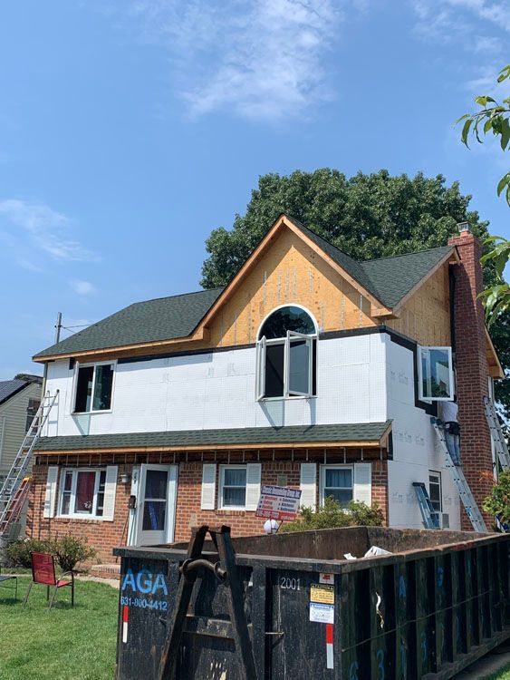 a house with a dumpster in front 