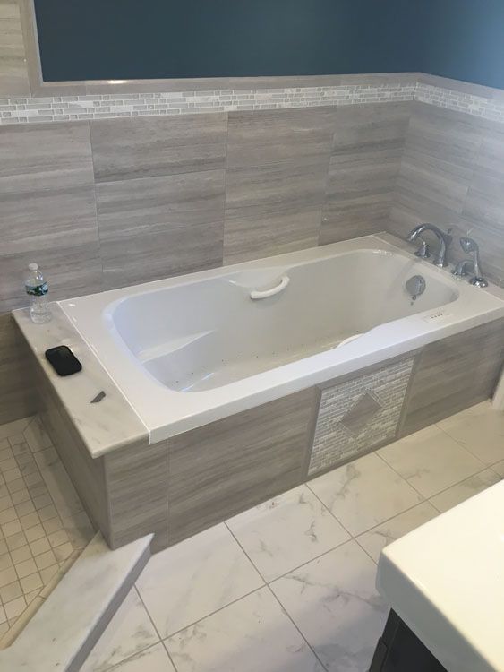 a bathtub in a bathroom next to a sink