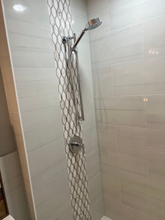 a shower with a tiled wall