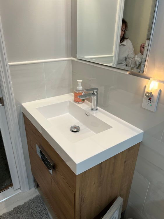 a bathroom sink with a wooden cabinet