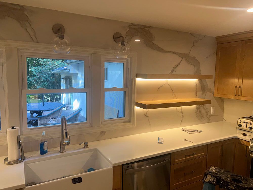 a kitchen with a sink, dishwasher, and a window