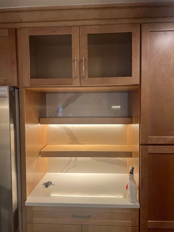 a kitchen with wooden cabinets and a stainless steel refrigerator