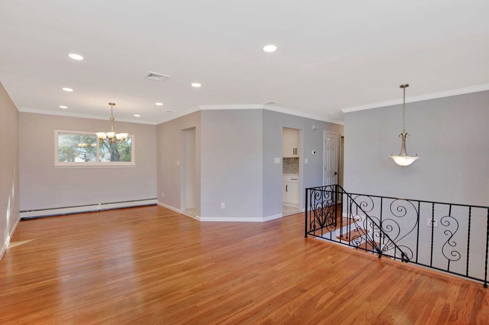 an empty living room with hardwood floors 