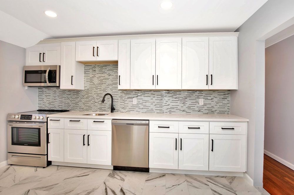 a kitchen cabinets and stainless steel appliances