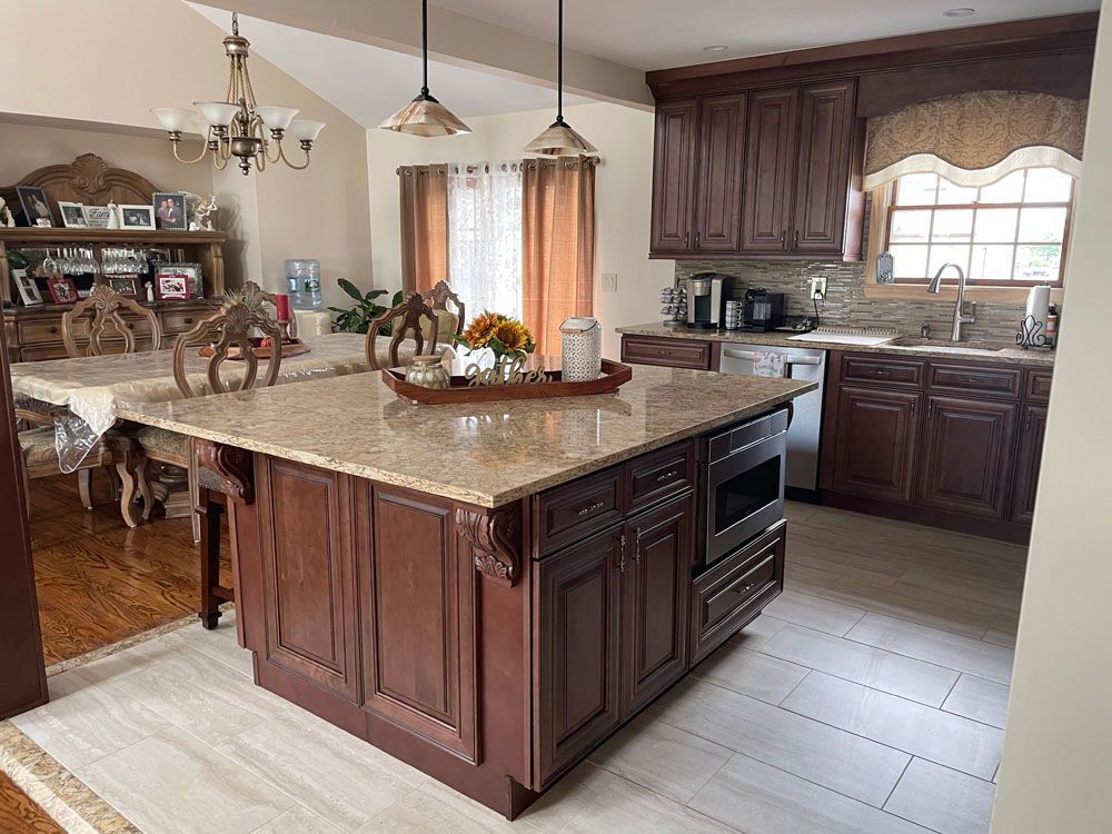 a kitchen with a large island in the middle and a dining room in the background