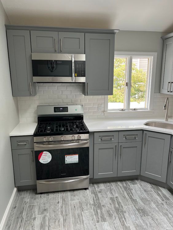 a kitchen with gray cabinets