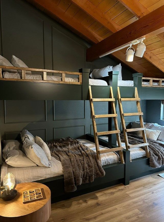 A room with four bunk beds and a ladder