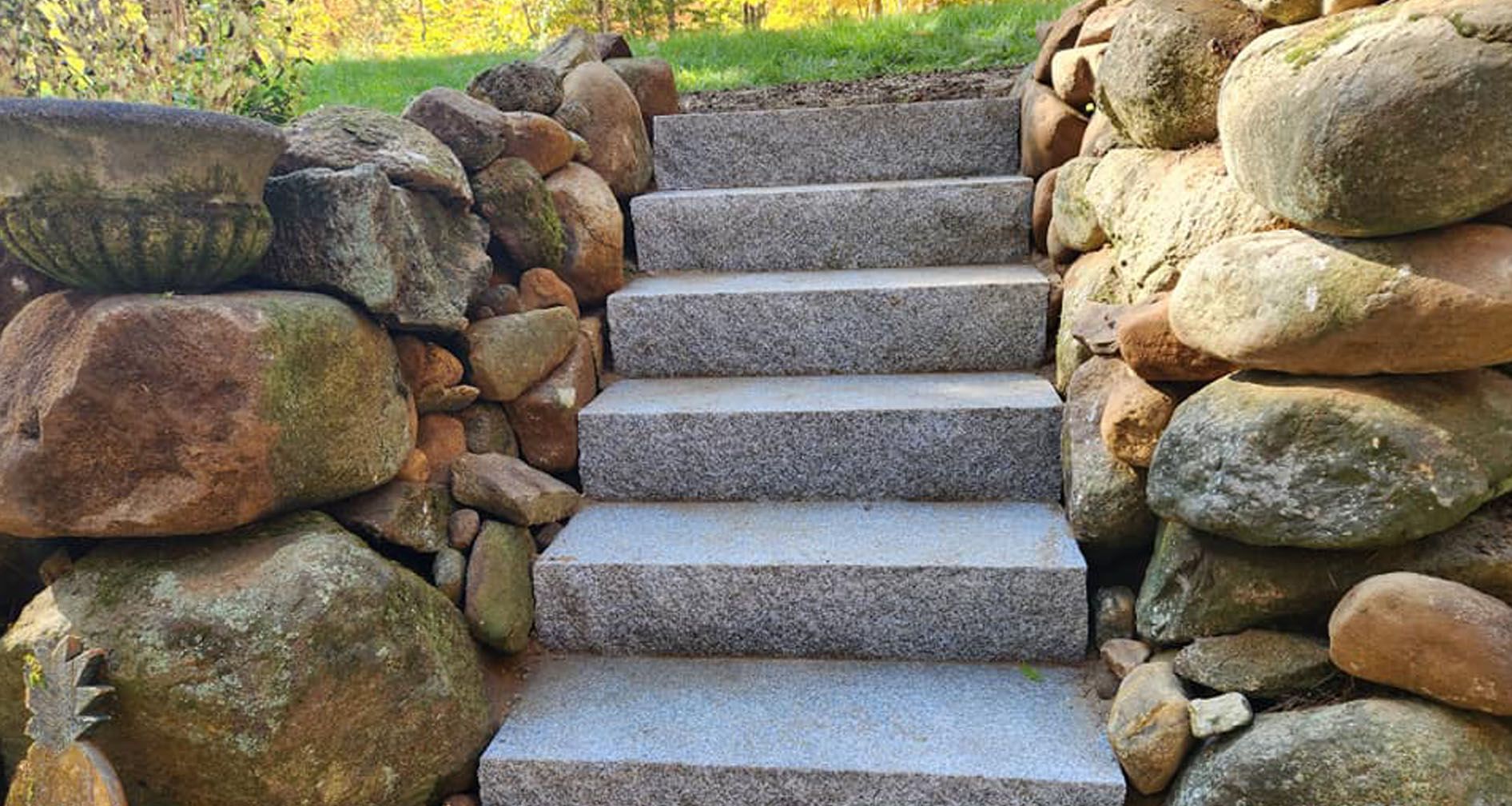a set of stairs leading up to a rock wall