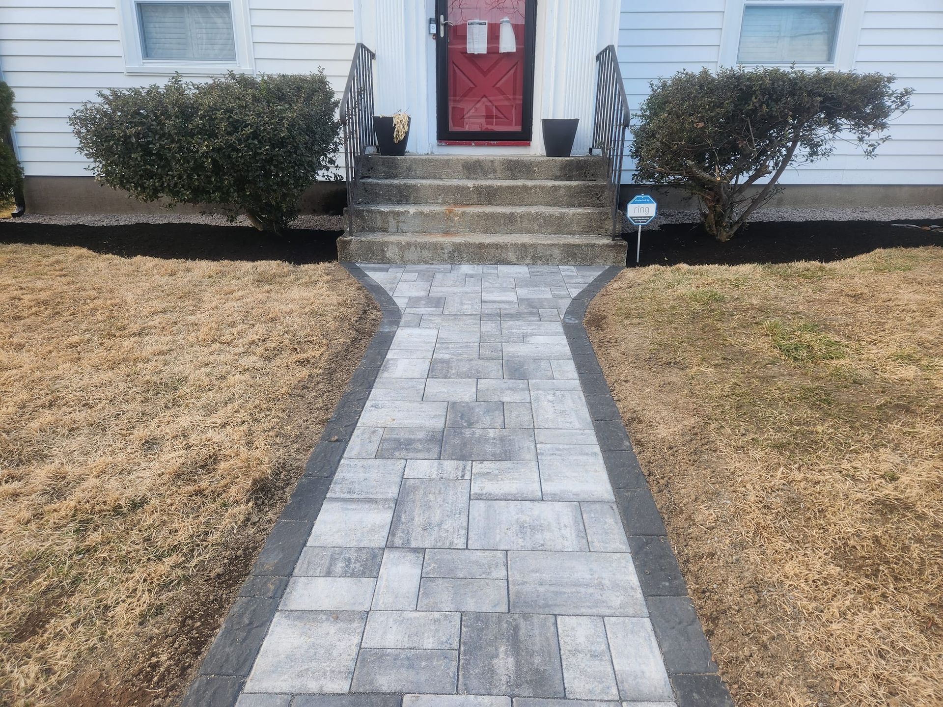 a brick walkway leading to the front door of a house