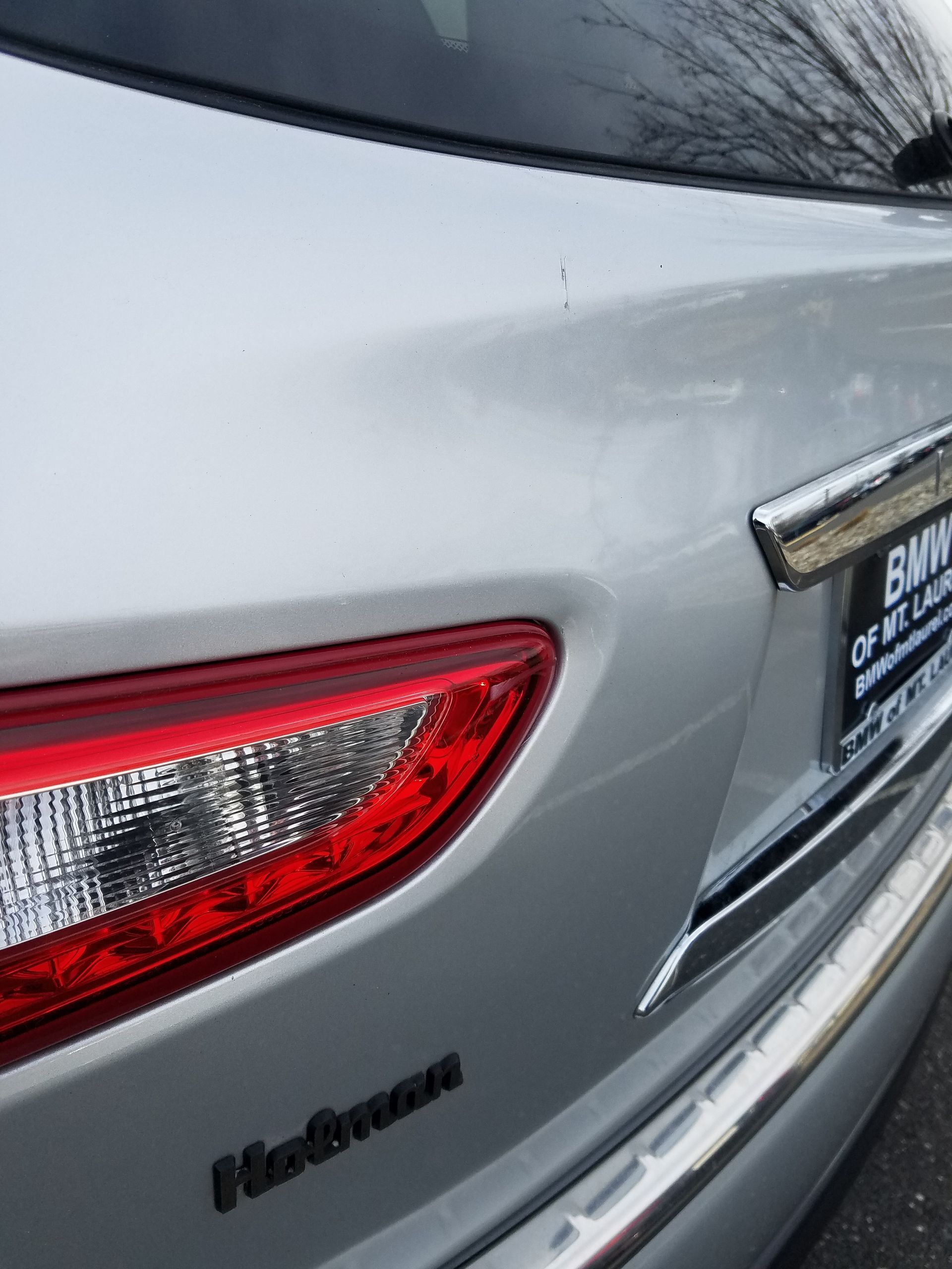 Rear corner of a silver Hyundai sedan, showing the taillight and trunk badge