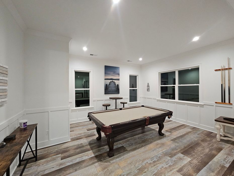 There is a pool table in the middle of the room.