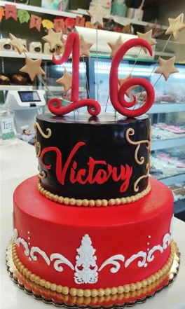 A red and black cake with the name victory on it
