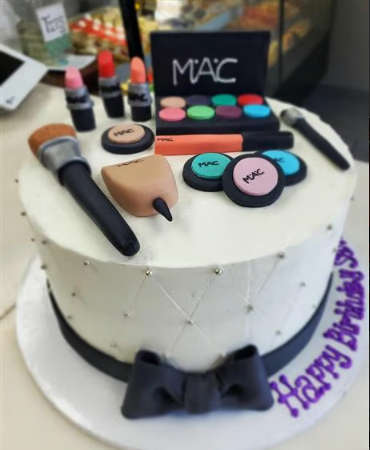 A birthday cake with mac makeup on it