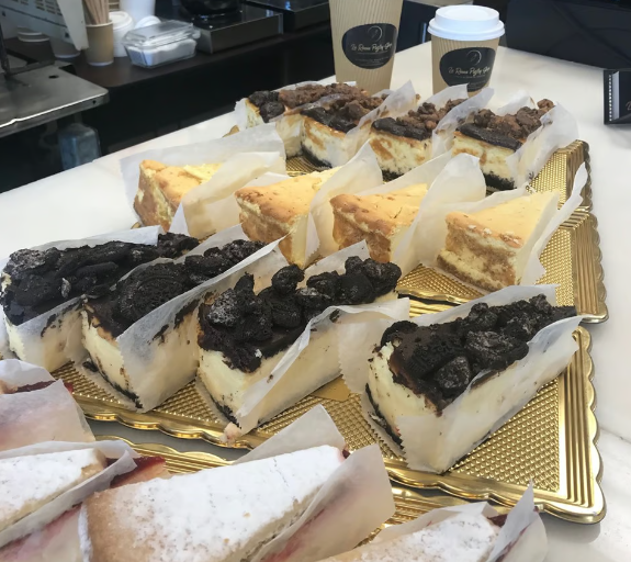 A bunch of slices of cheesecake on a table