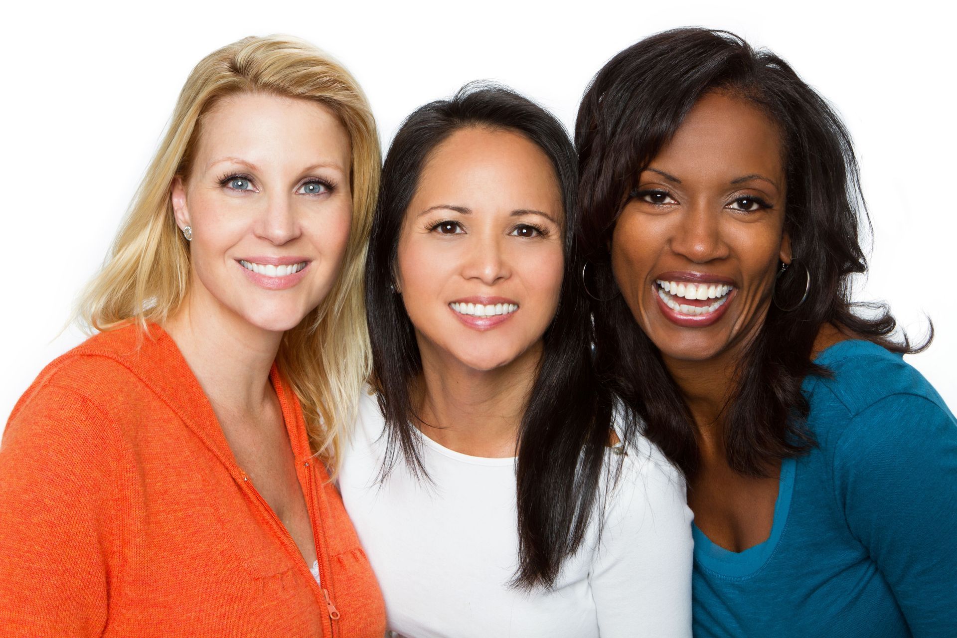 Three smiling women, diverse skin tones, close-up, against white background.
