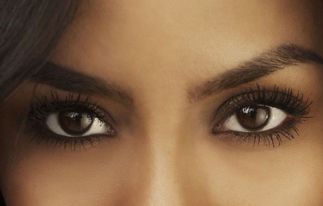 Close-up of a person's eyes with dark eyeliner and long eyelashes