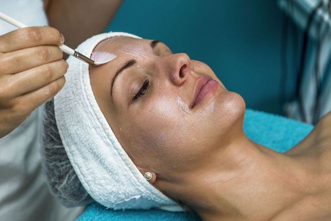 Woman receiving facial treatment