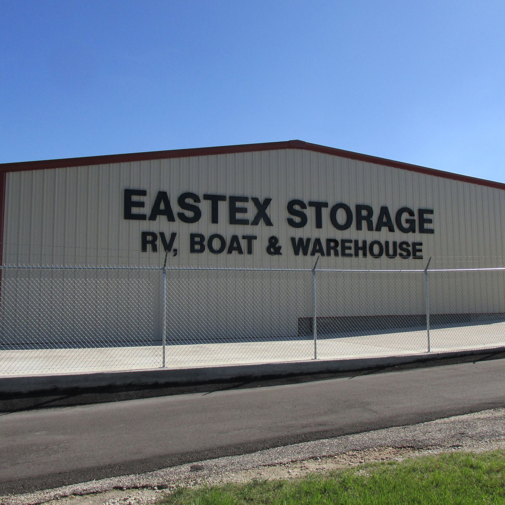 The exterior of a beige metal building labeled 