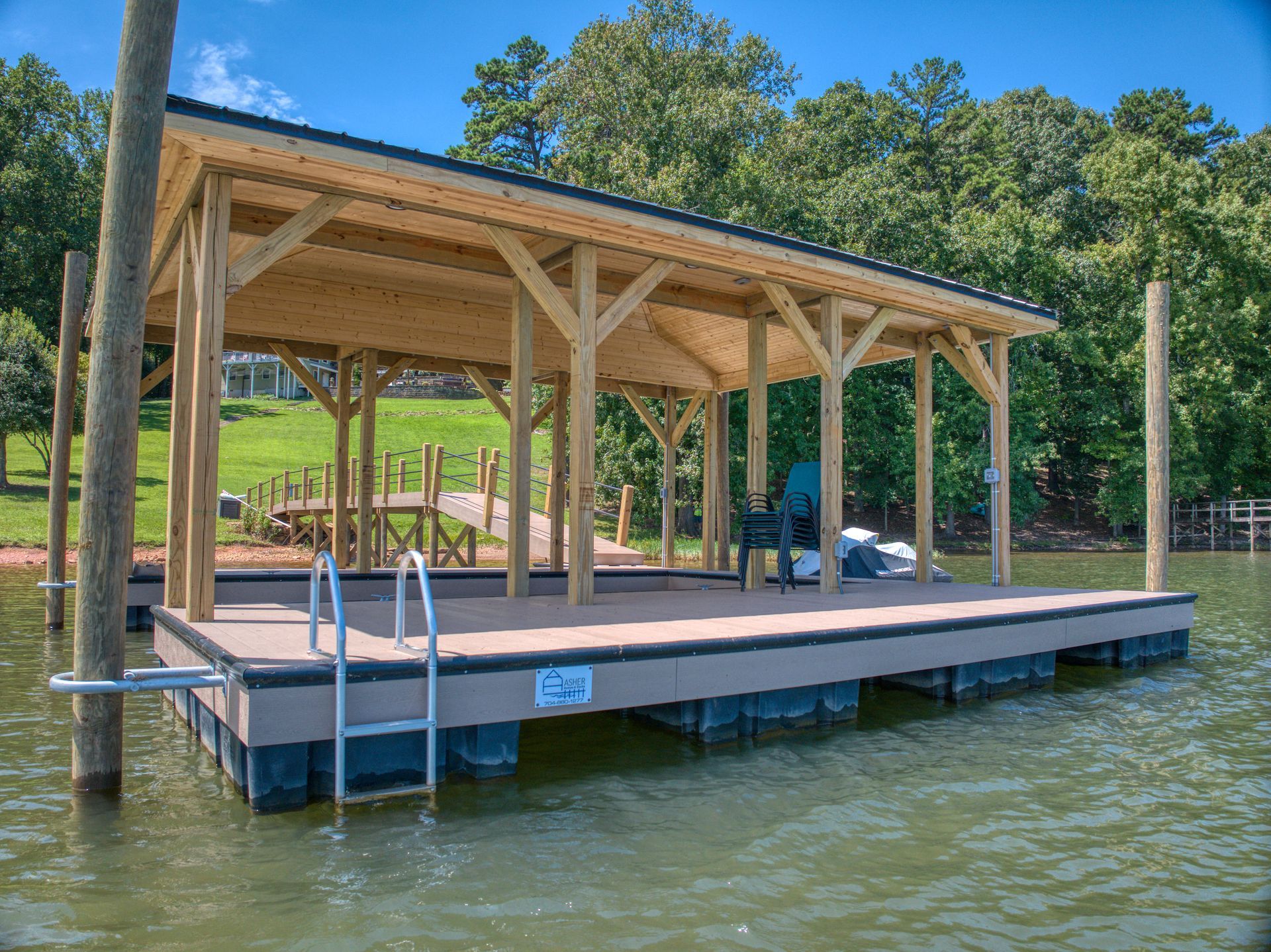 Dock with wooden roof and ladder extending into water.