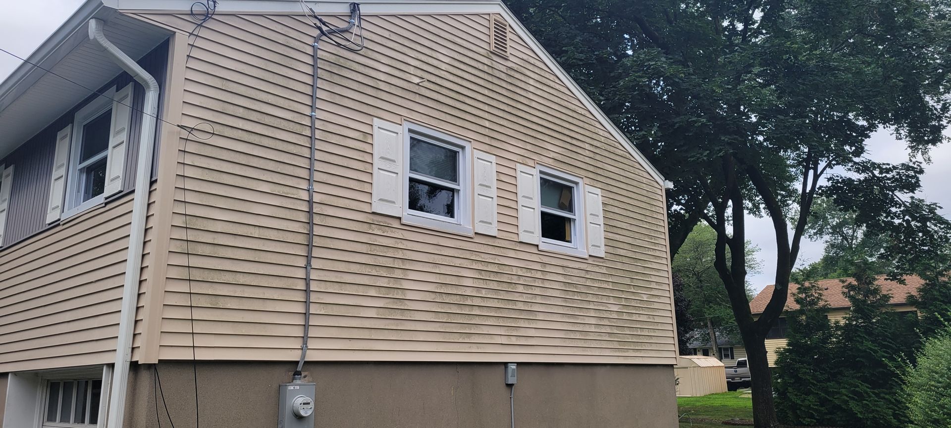 A house with a broken window on the side of it