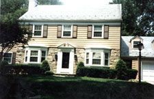 A large house with a lot of windows and a garage.
