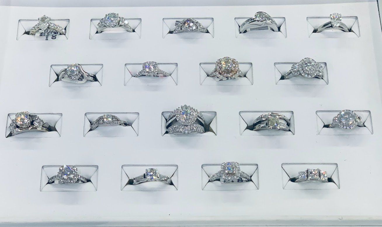A variety of rings are displayed on a white tray.