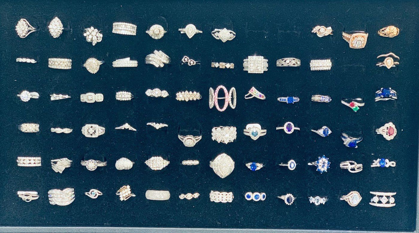 A display of silver jewelry with the number 100 at the top