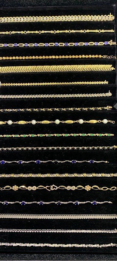 A display case filled with lots of different types of bracelets.