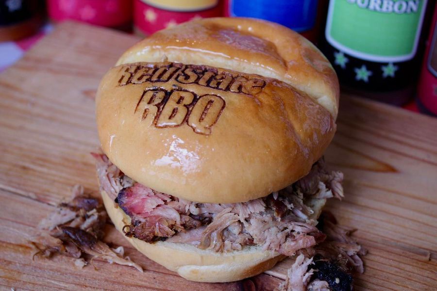 A pulled pork sandwich on a branded