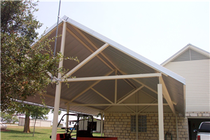 A carport with a forklift underneath it