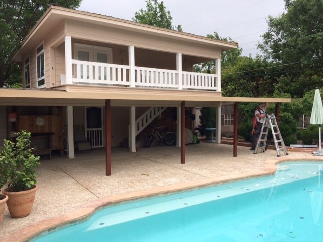 A house with a swimming pool in front of it