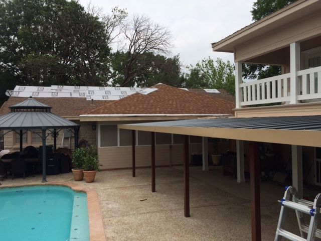 A house with a gazebo and a pool in front of it