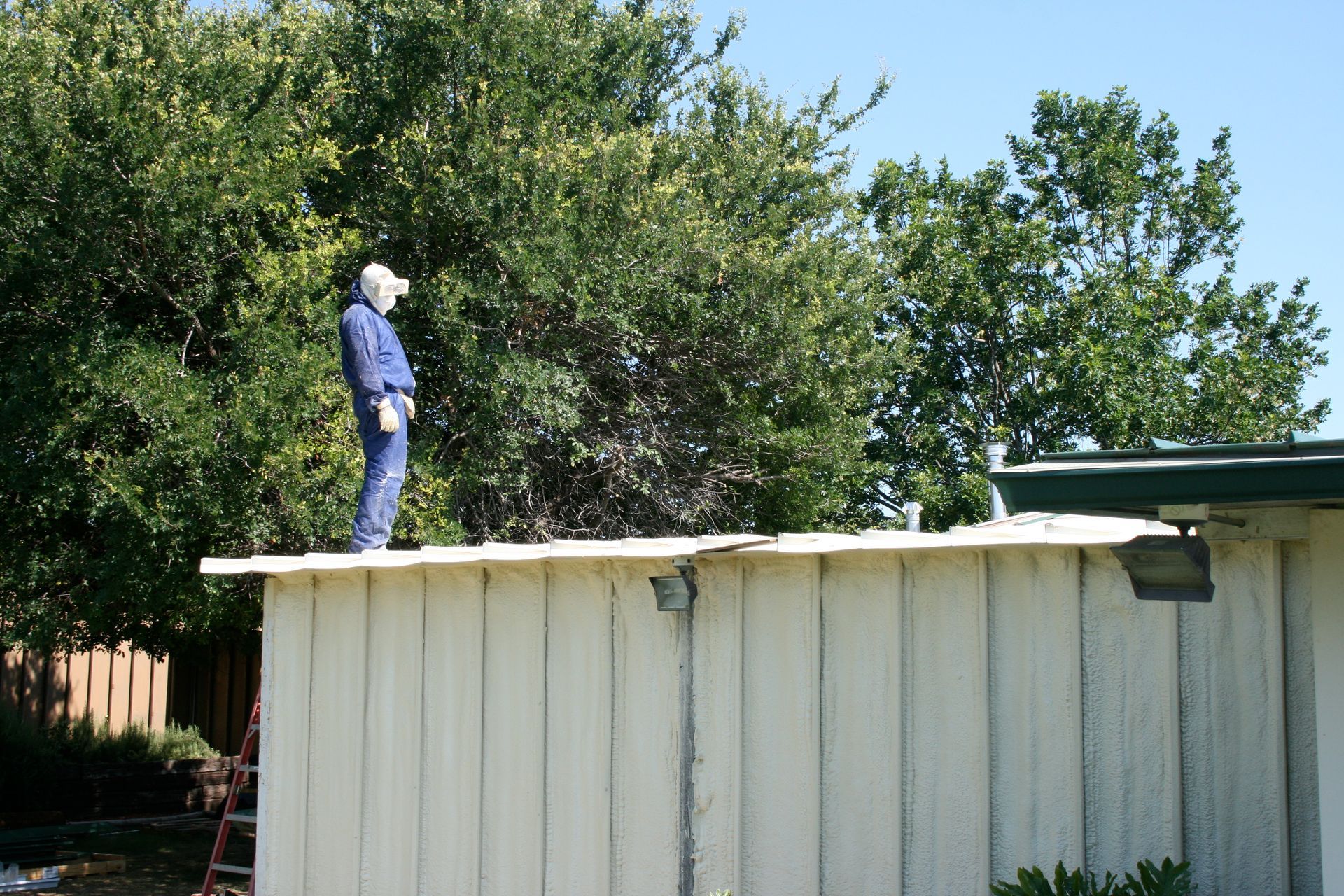 A man standing on top of a white building