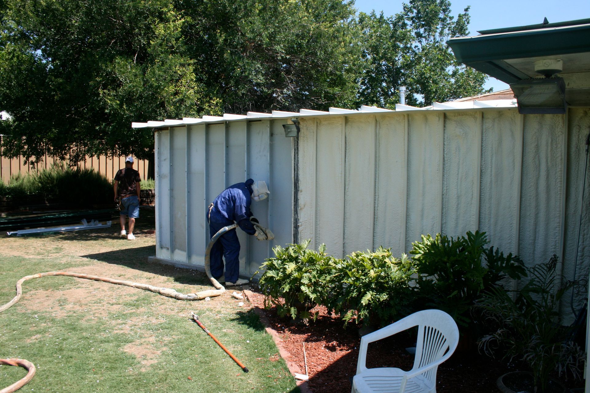 A man is spray painting the side of a building