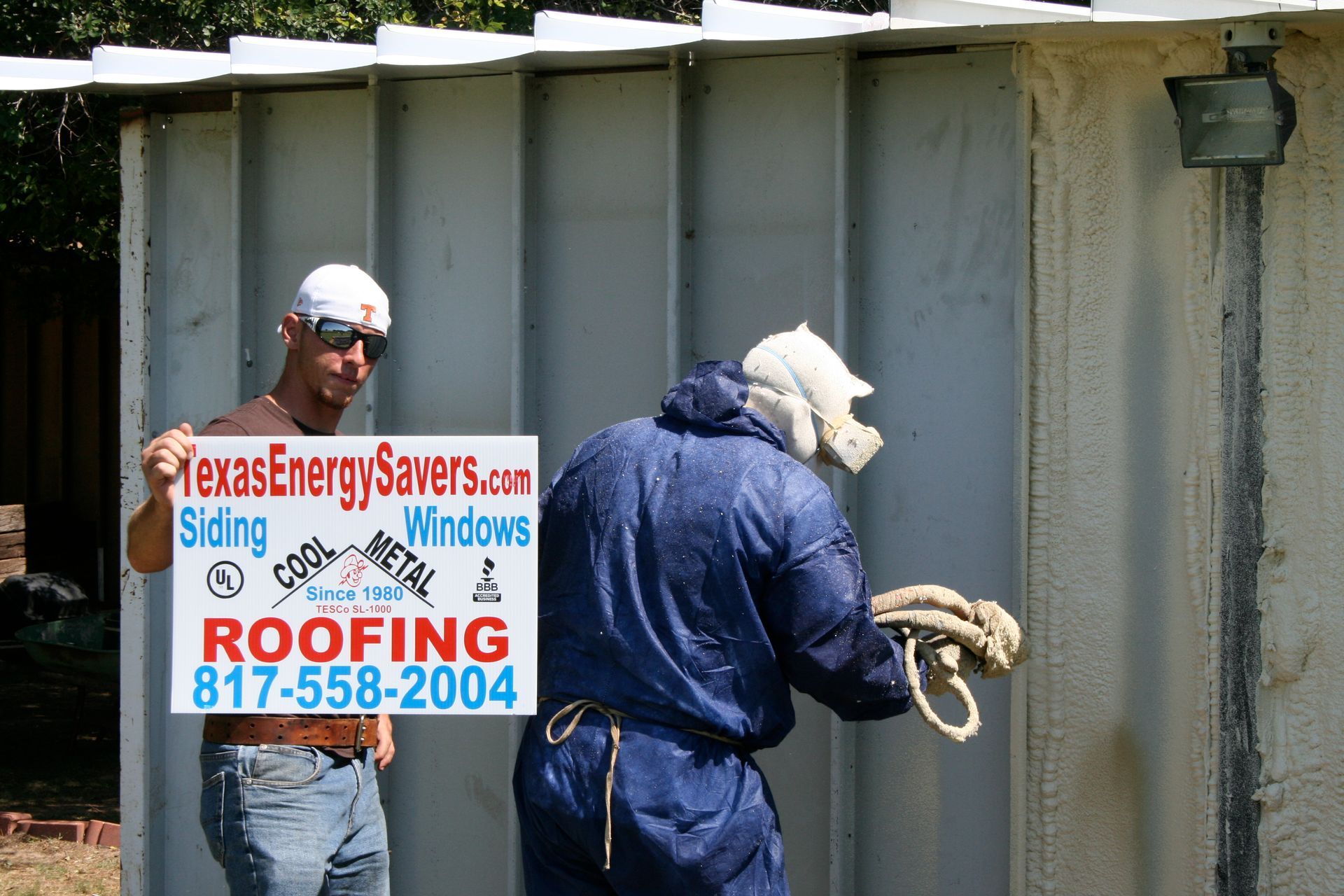 A man holding a sign that says roofing on it