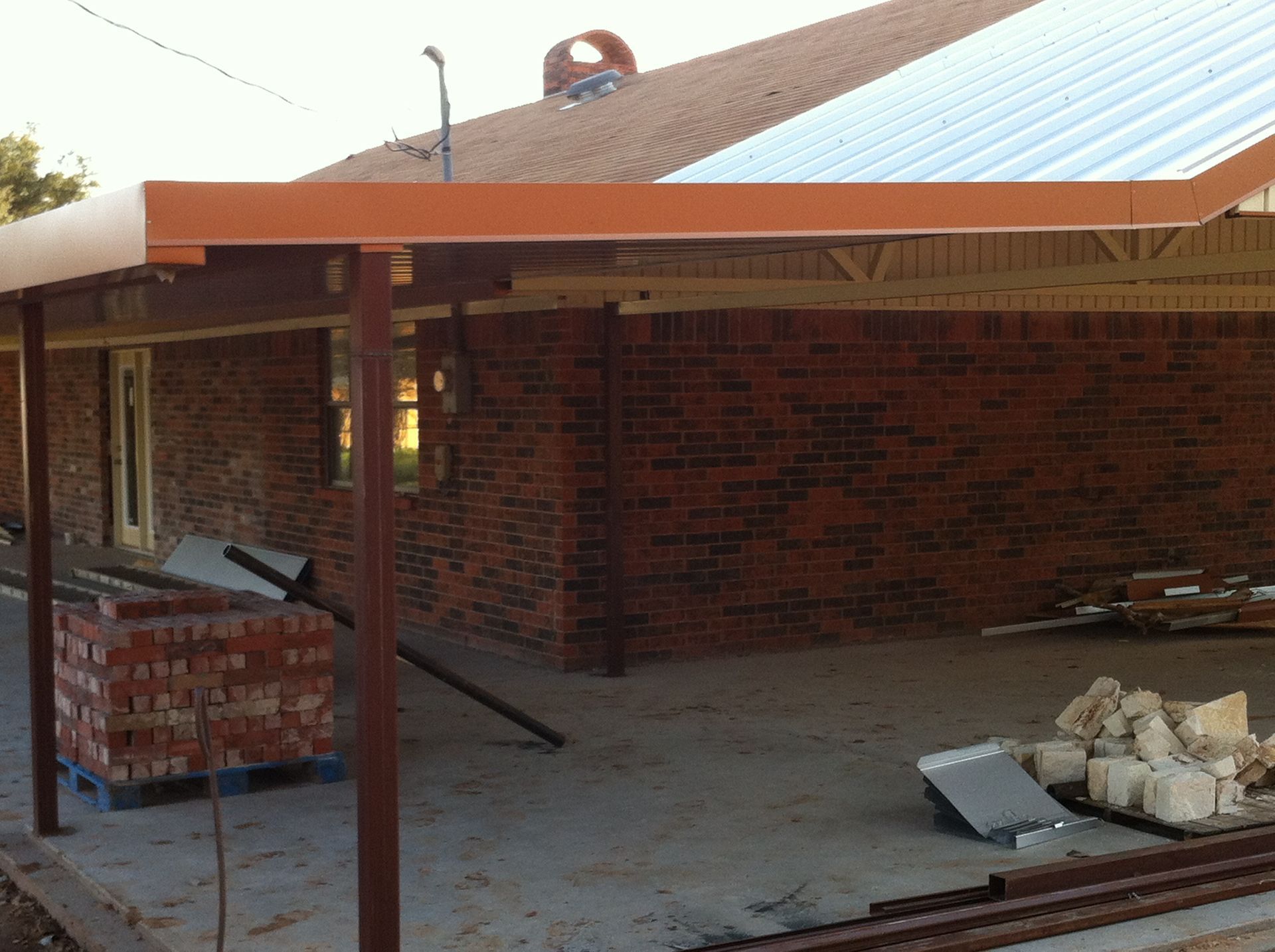 A brick building under construction with a roof