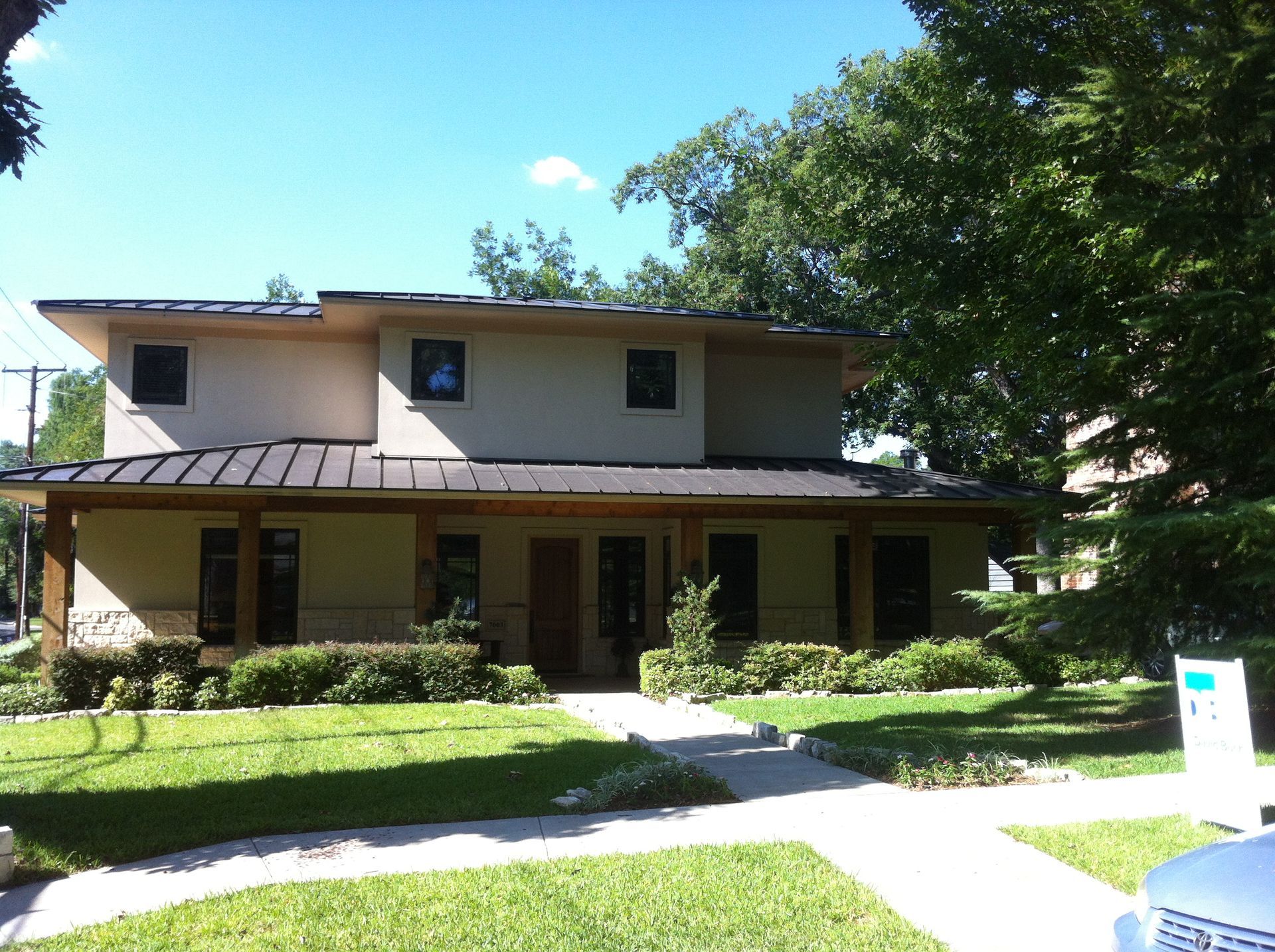 A large house with a metal roof is for sale