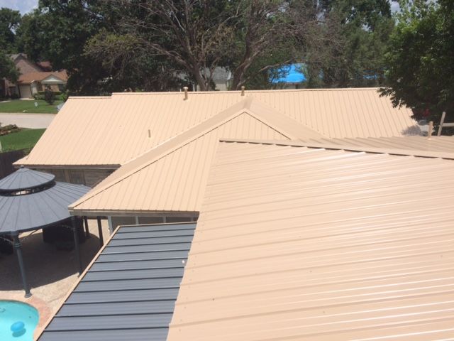 The roof of a house with a pool in the backyard.