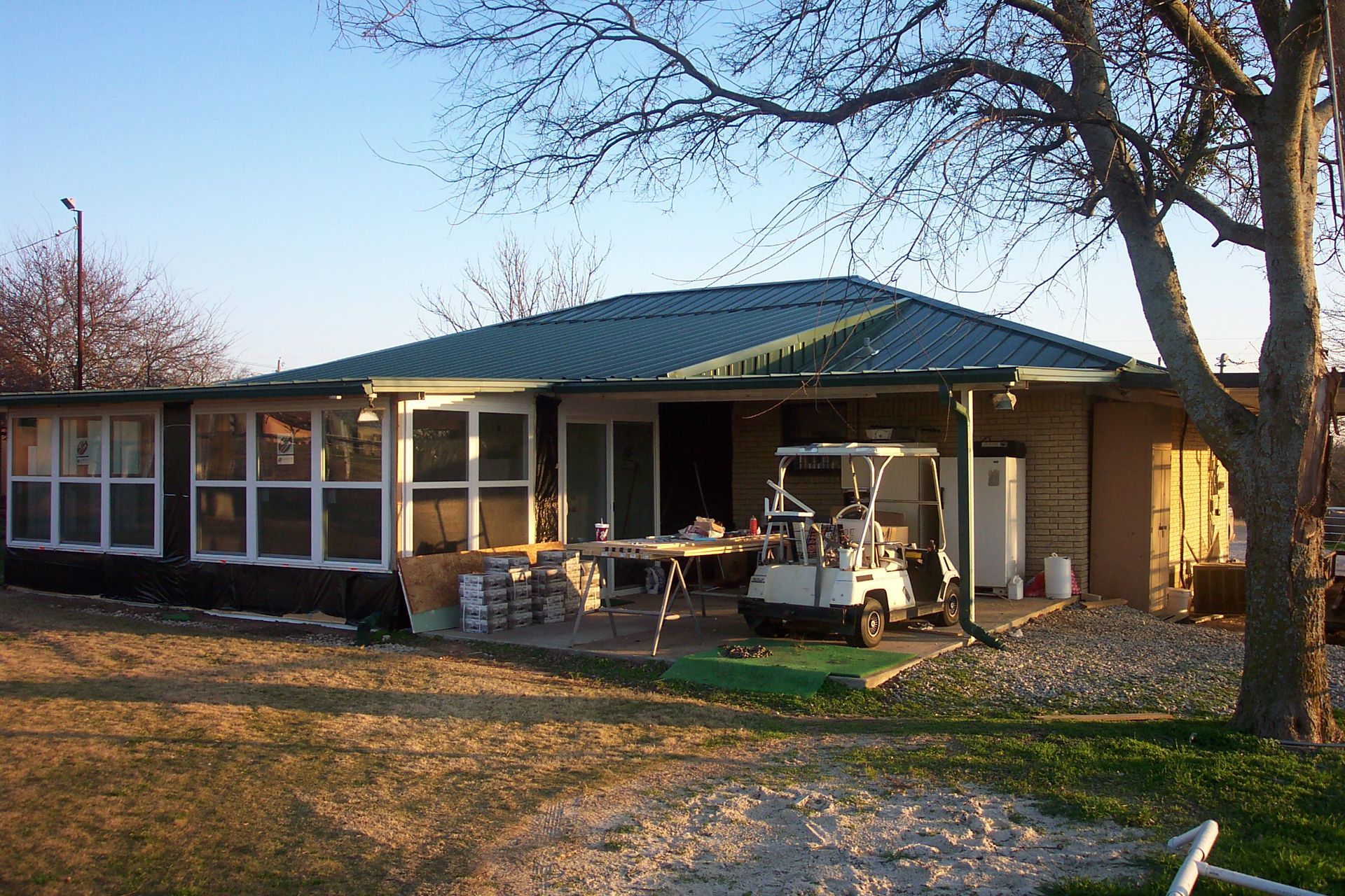 A house with a golf cart parked in front of it