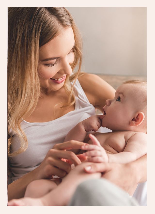 A man and a woman are holding a baby