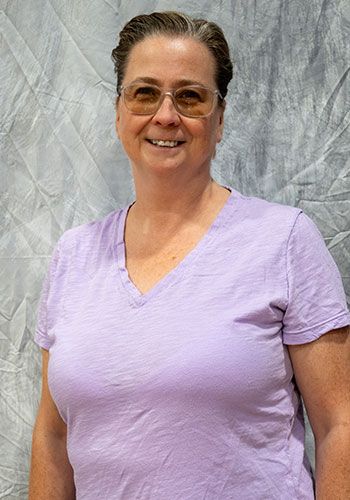 Silhouette of a person with short hair, against a gray background.