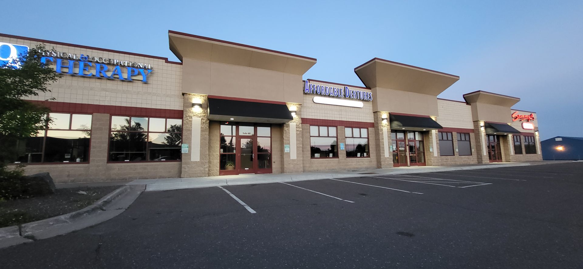 A large building with a lot of windows and a sign that says therapy