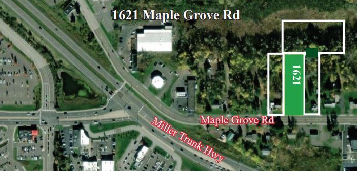 a view of the 1621 Maple Grove Rd property with a few buildings and trees