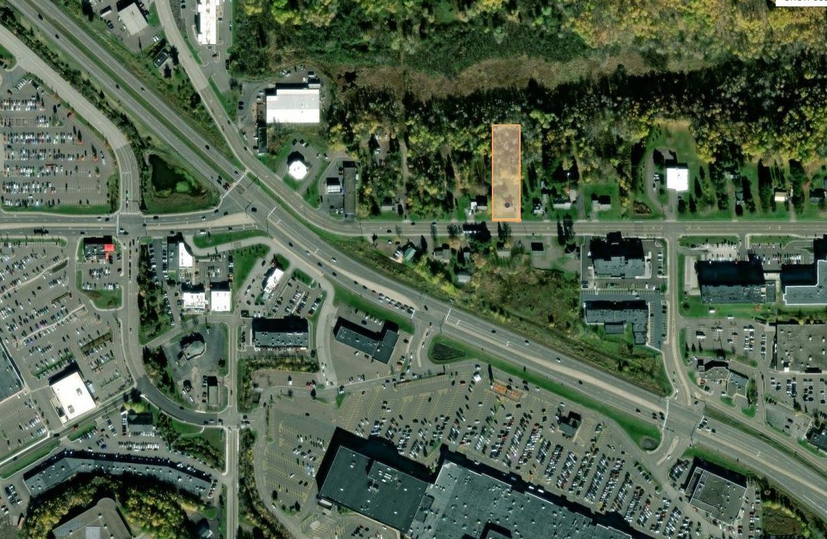 an aerial view of the 1621 Maple Grove Rd property with a few buildings and trees