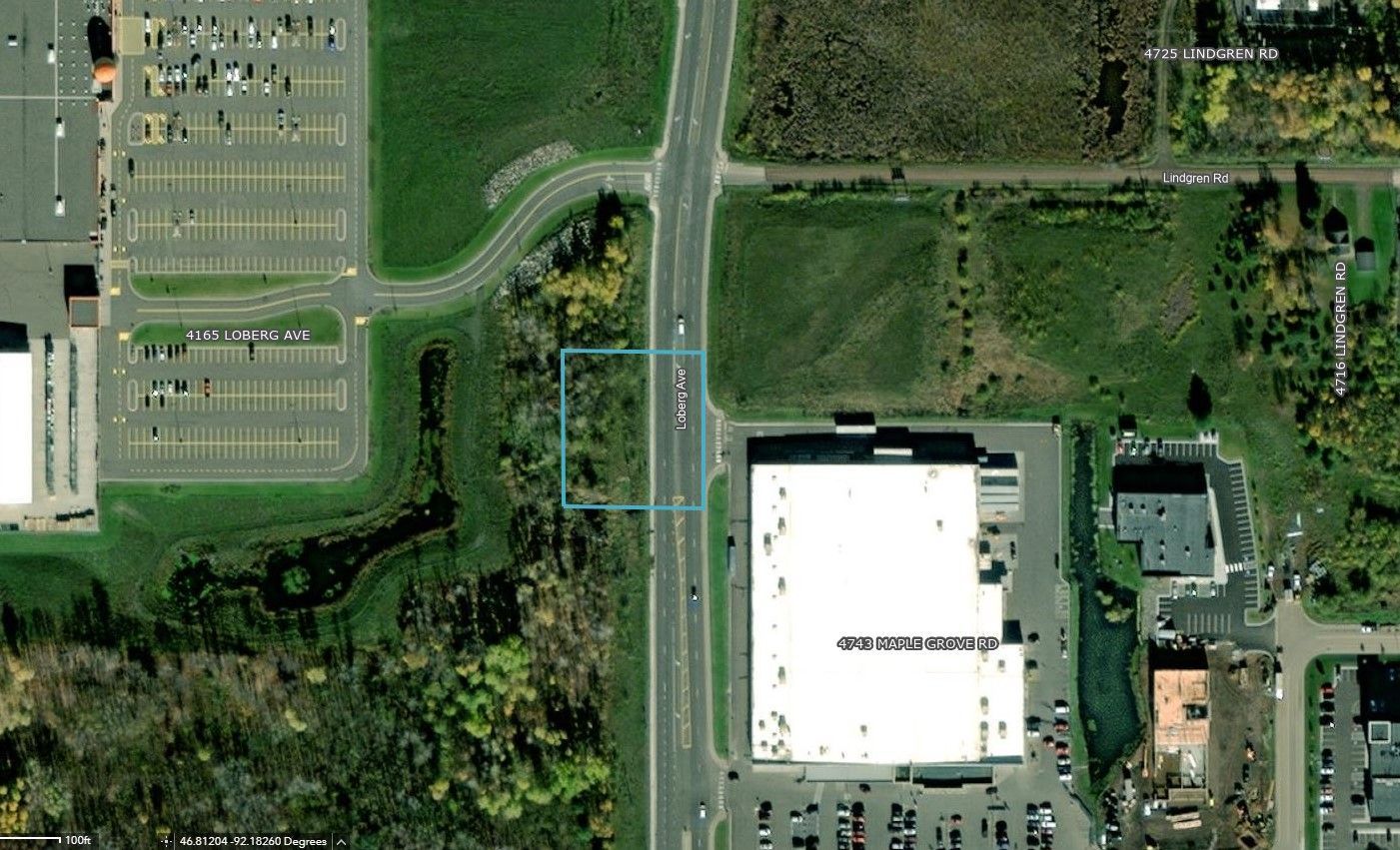 an aerial view of a city with a white building in the middle