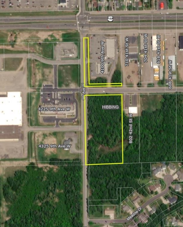 an aerial view of a residential area with a few buildings and trees