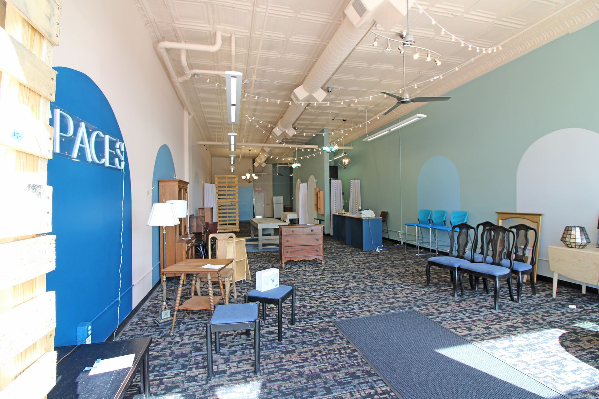 a large room with a sign that says spaces on it