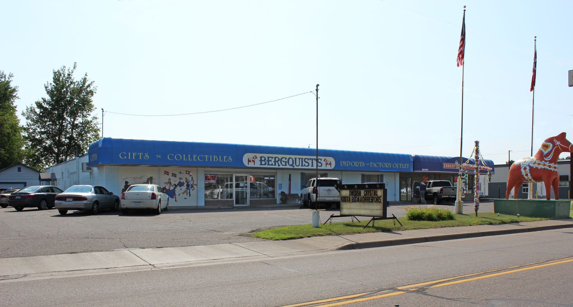 a store front with a statue of a horse in front of it