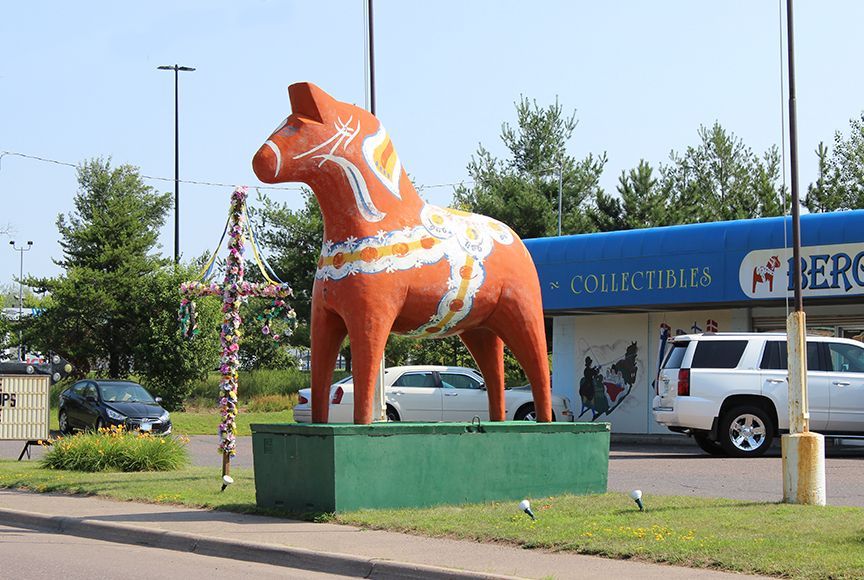 a statue of a horse in front of a collectibles store